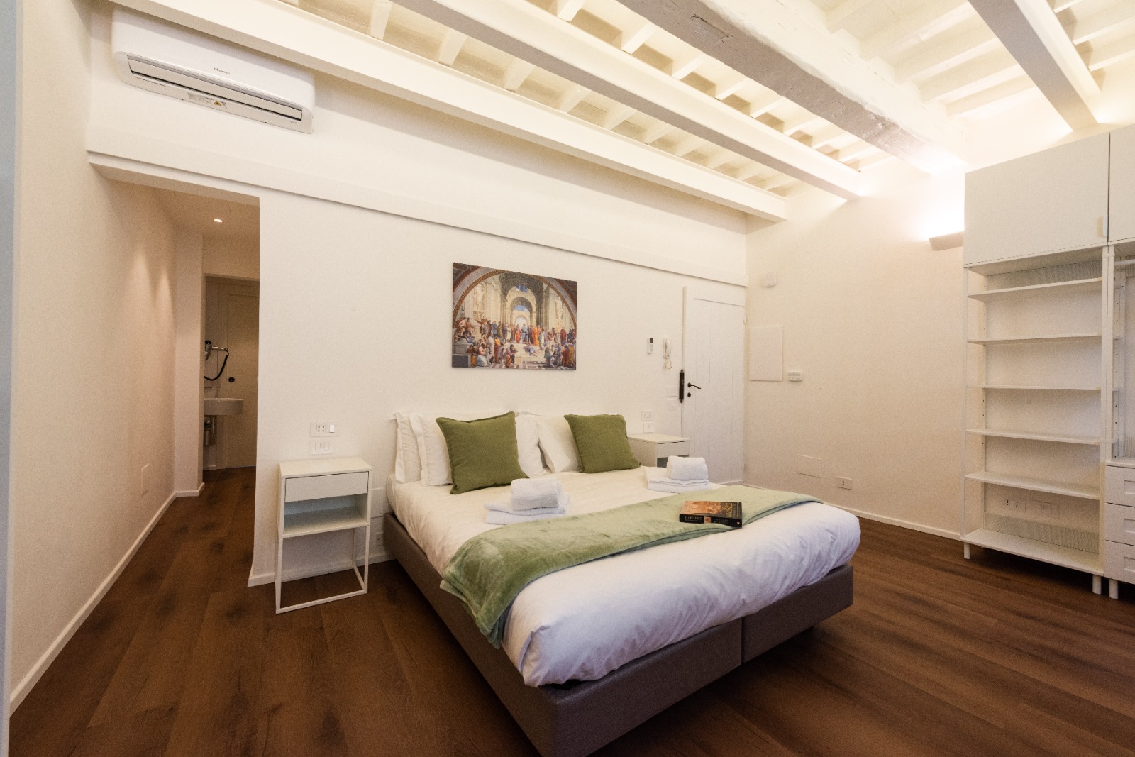 Bedroom with Renaissance art and beam ceiling