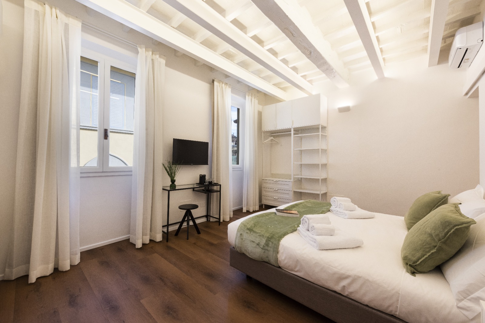 Elegant bedroom with beam ceiling