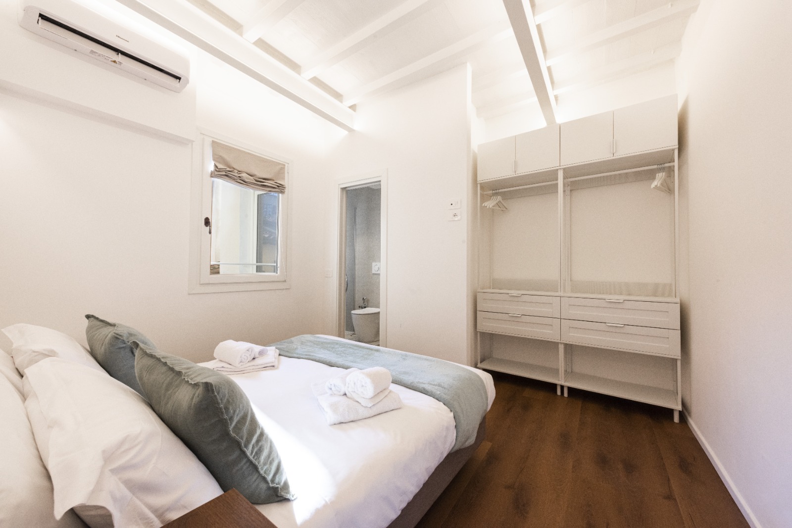 Bedroom with open wardrobe and en-suite