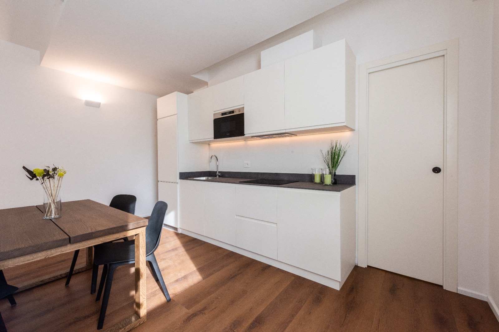 Sleek white kitchen with under-cabinet lighting